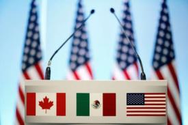 image of podium with Canadian, Mexican, US flags